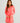 Woman modeling a bright pink long-sleeve women's beach cover-up with side ties against a light background.