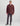 Burgundy fleece shacket with chest pockets and button front, worn with gray jeans and olive beanie.