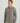 Man wearing gray 1/4 zip fleece pullover with brand logo on chest and tan pants.