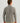 Man wearing gray lightweight fleece pullover with quarter-zip neckline and long sleeves, shown from back view.