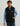 Man wearing HUK Men's Helm Fleece Vest in Black