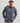 Man wearing blue tie-dye 1/2 zip fleece hoodie with kangaroo pocket over black shirt and tan pants.