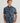 Men's short sleeve button-down shirt in blue with dark abstract pattern and chest pockets.