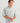 Men's light gray heathered button-down shirt with chest pocket and rolled sleeves.