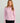 Women's light pink long-sleeve pullover with quarter-zip front closure and mock neckline.
