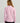 Woman wearing a pink long-sleeve quarter-zip pullover with black pants, shown from the back.