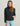 Woman wearing HUK Women's Coldfront+ Fleece Hoodie in Heather Black