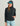 Woman wearing HUK Women's Coldfront+ Fleece Hoodie in Heather Black