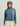 Woman wearing HUK Women's Leeward Boxy Fleece Hoodie in Stormy Blu Heather