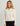 Woman wearing HUK Women's Camden Snap Fleece Pullover in Egret