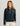 Woman wearing HUK Women's Camden Snap Fleece Pullover in Sea Storm Heather