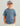 Child wearing slate blue short-sleeve tee with small blue graphic on chest, paired with cream pants and light blue baseball c