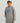 Child wearing gray Huk hoodie with blue logo and front pocket.