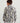 Child wearing a camouflage patterned 1/4 zip fleece pullover in gray, black, and yellow, viewed from the back.