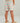 Kids swim shorts with coral, teal, and tan beach-themed print, elastic waistband, and side pocket.