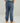Child wearing slate blue cargo joggers with side pockets and elastic cuffs, paired with tan and white sneakers.