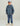 Child wearing navy quilted hooded jacket with light blue zip and matching navy pants.