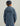 Child wearing blue quilted hooded jacket with scale pattern, shown from back view.