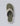 A single flip-flop sandal shown from a top-down view on a light gray background. The sandal features an olive green ribbed footbed, a white outer edge, and a camouflage-patterned strap with a debossed 'U' logo.